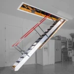 Majic_Folding_Stairways_Extended_From_A_Ceiling_With_Red_Handrails_And_Metal_Steps_In_A_Garage_Setting