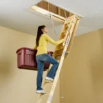 woman-climbing-a-werner-wood-attic-ladder